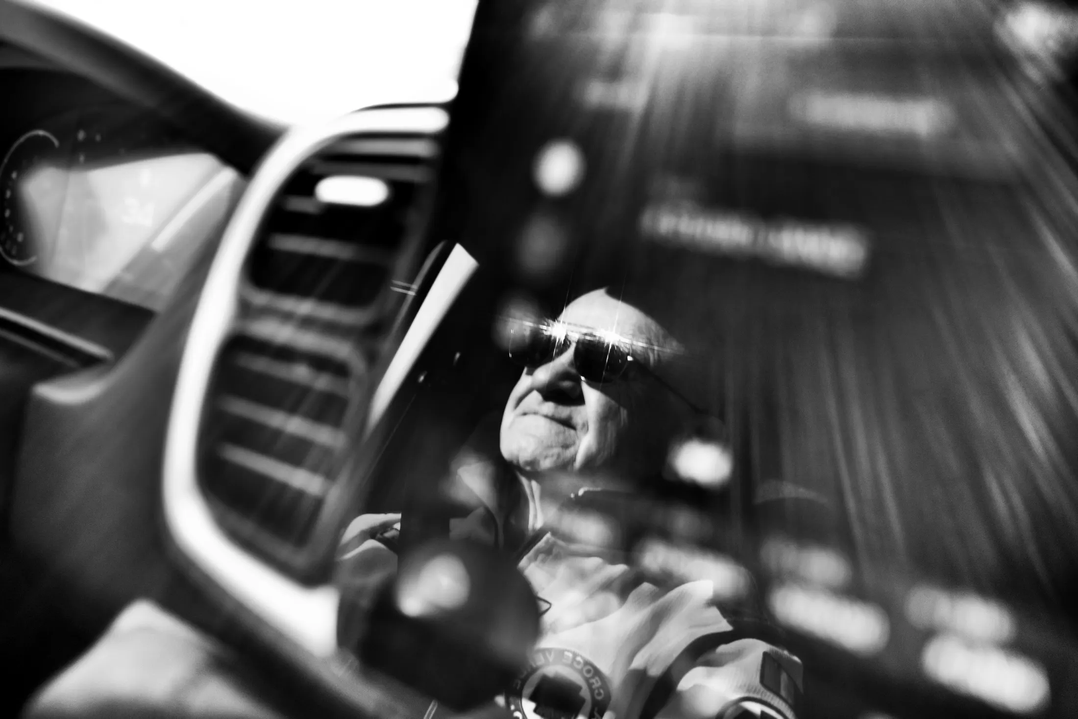 Volunteer driving the ambulance seen from inside the cab, black and white