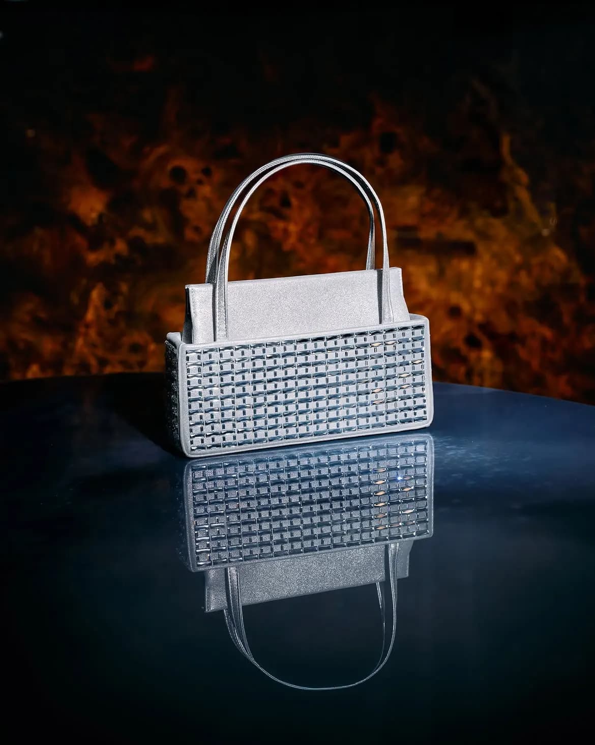 Silver dress on a blue velvet sofa, crystal clutch and slingbacks