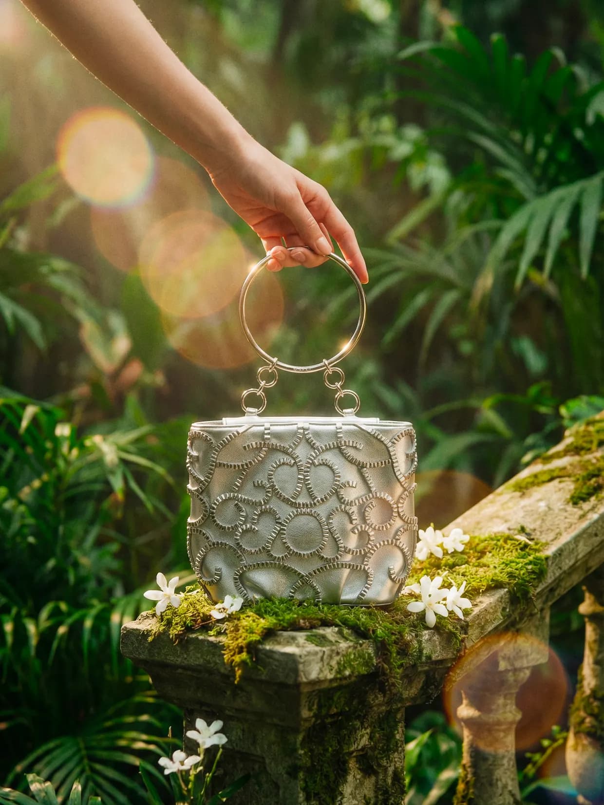 Generated image: hand placing a white top-handle bag on a moss-covered boulder