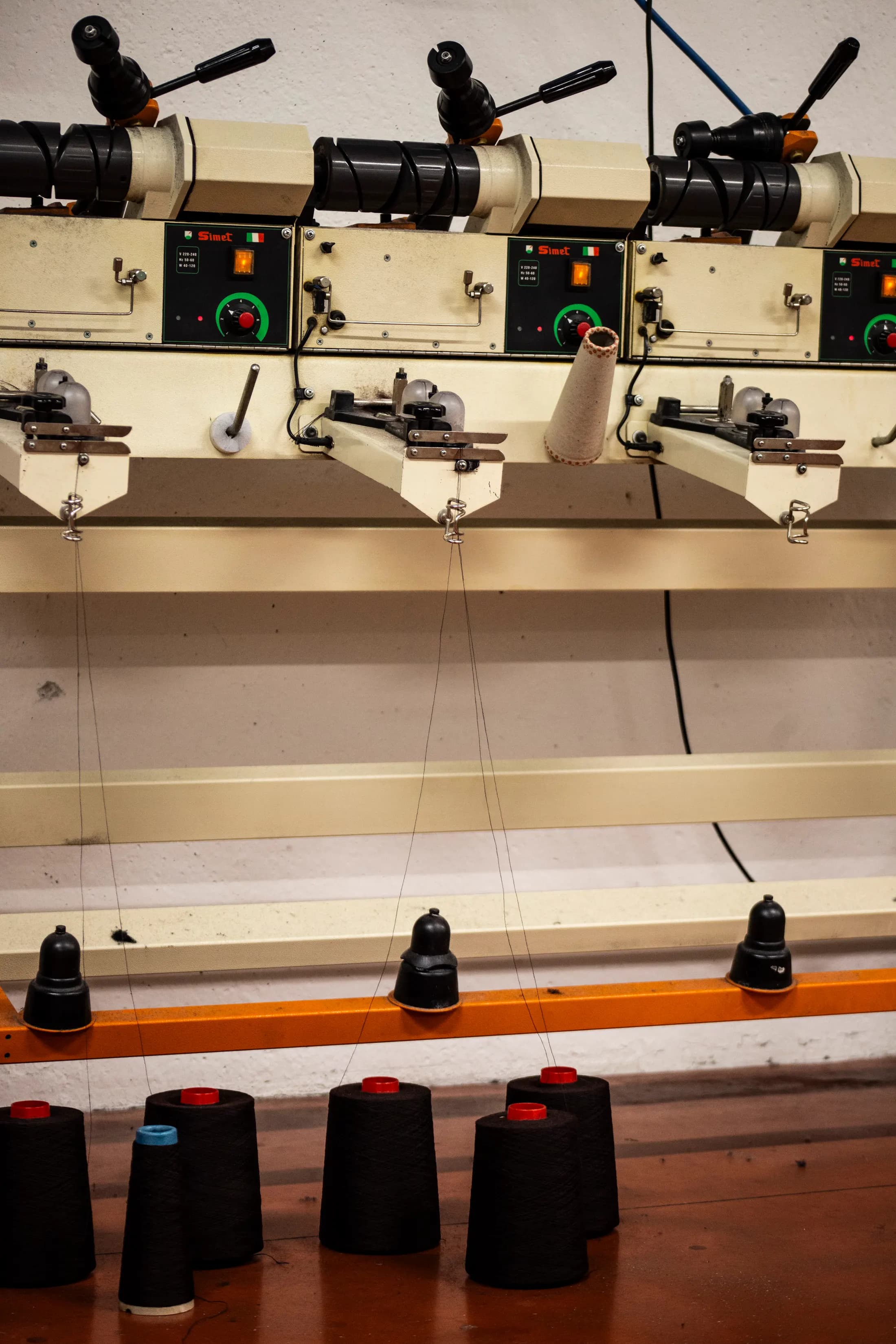 Row of linking machines with dark cones ready on the bench