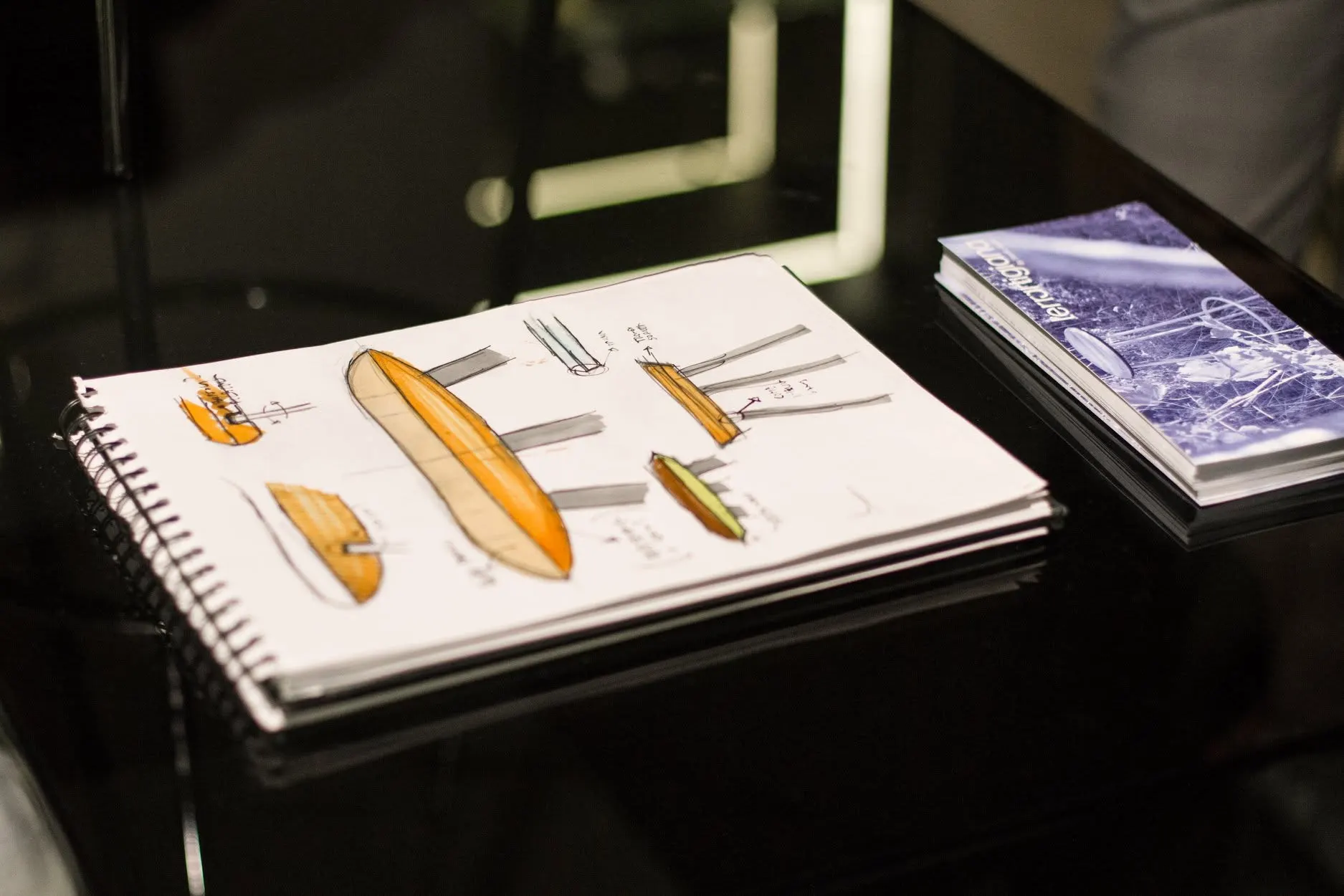 Open notebook with the design sketches of the objects, in the window