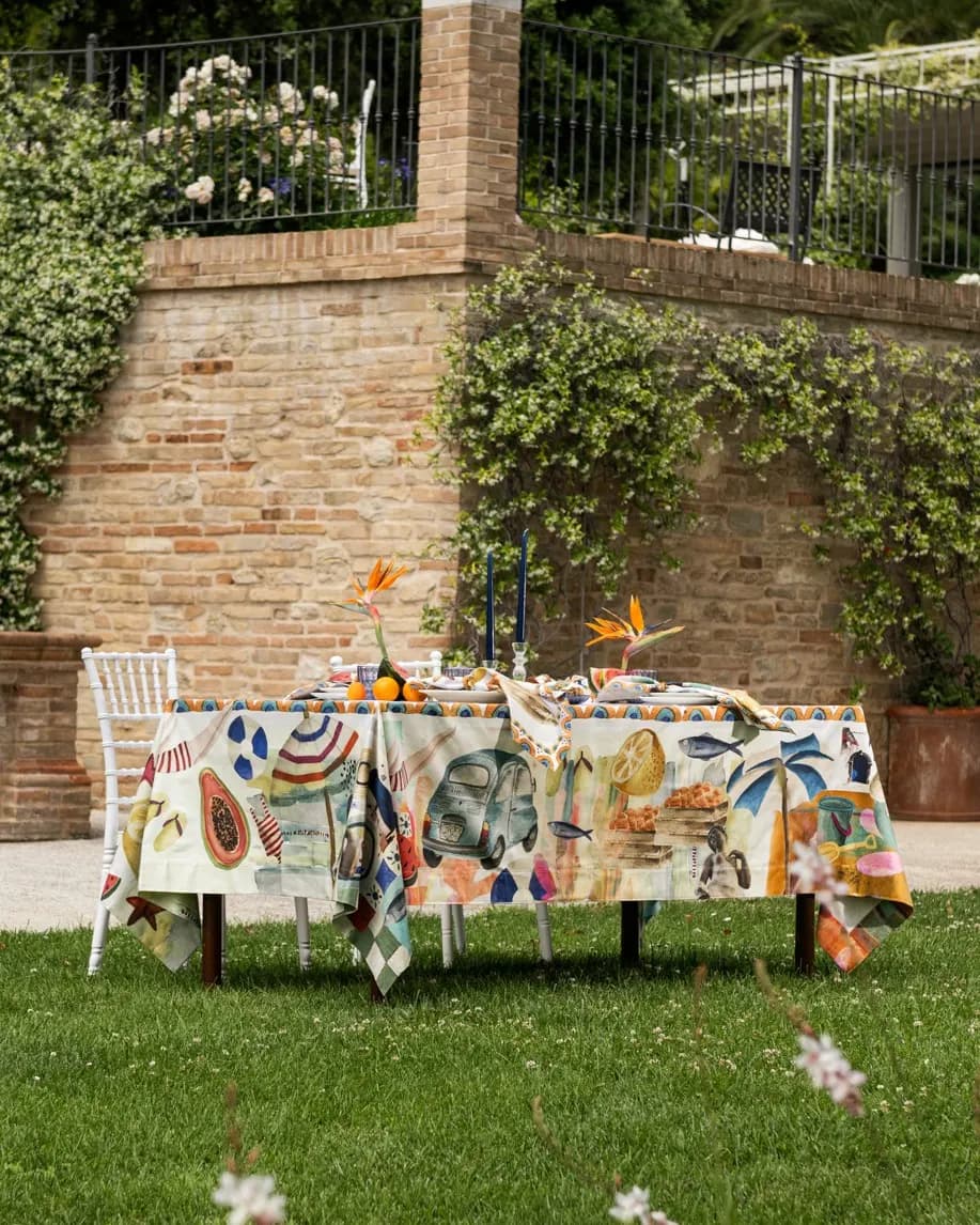 Garden table against a brick wall, colourful print tablecloth
