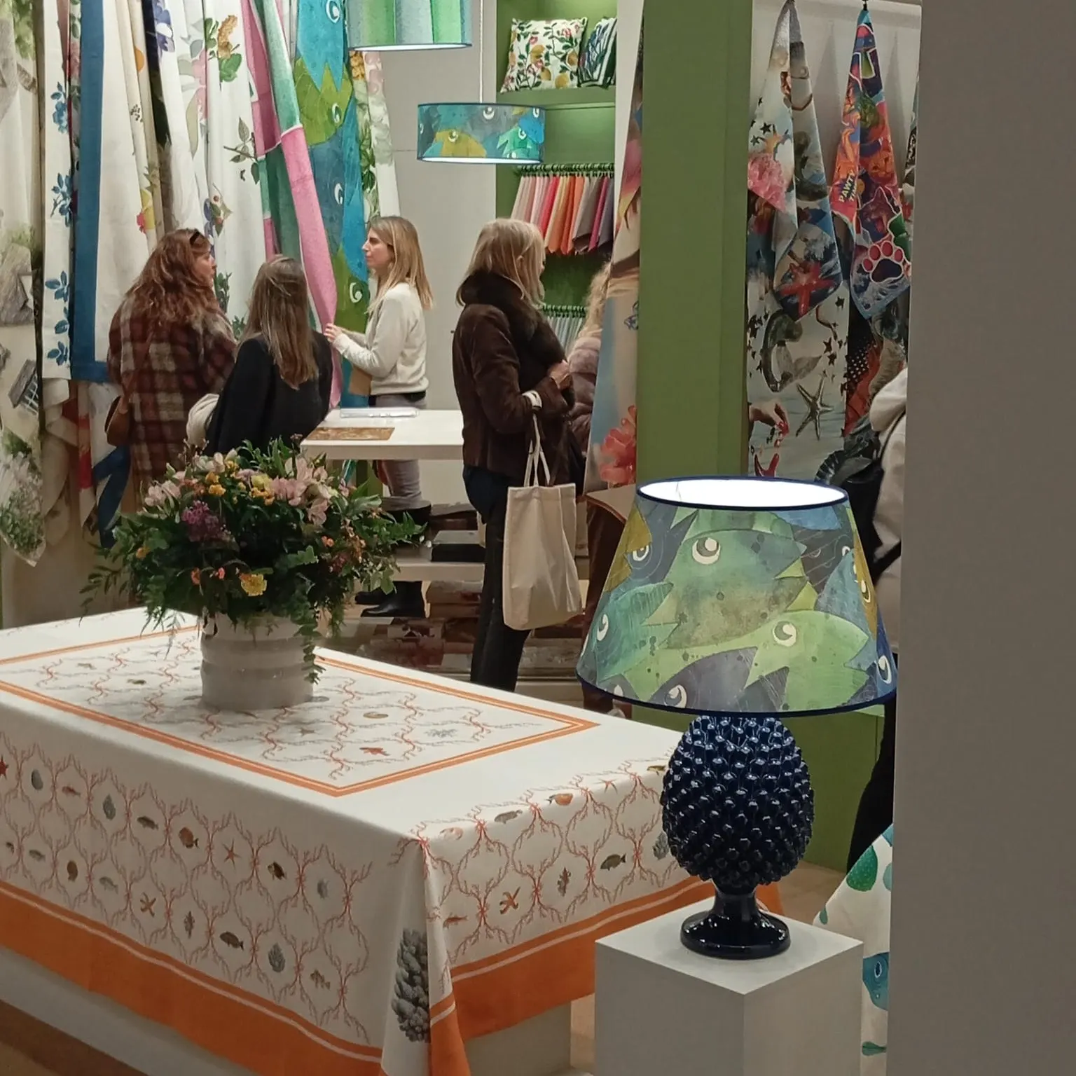 Stand table with a blue ceramic lamp and an embroidered tablecloth